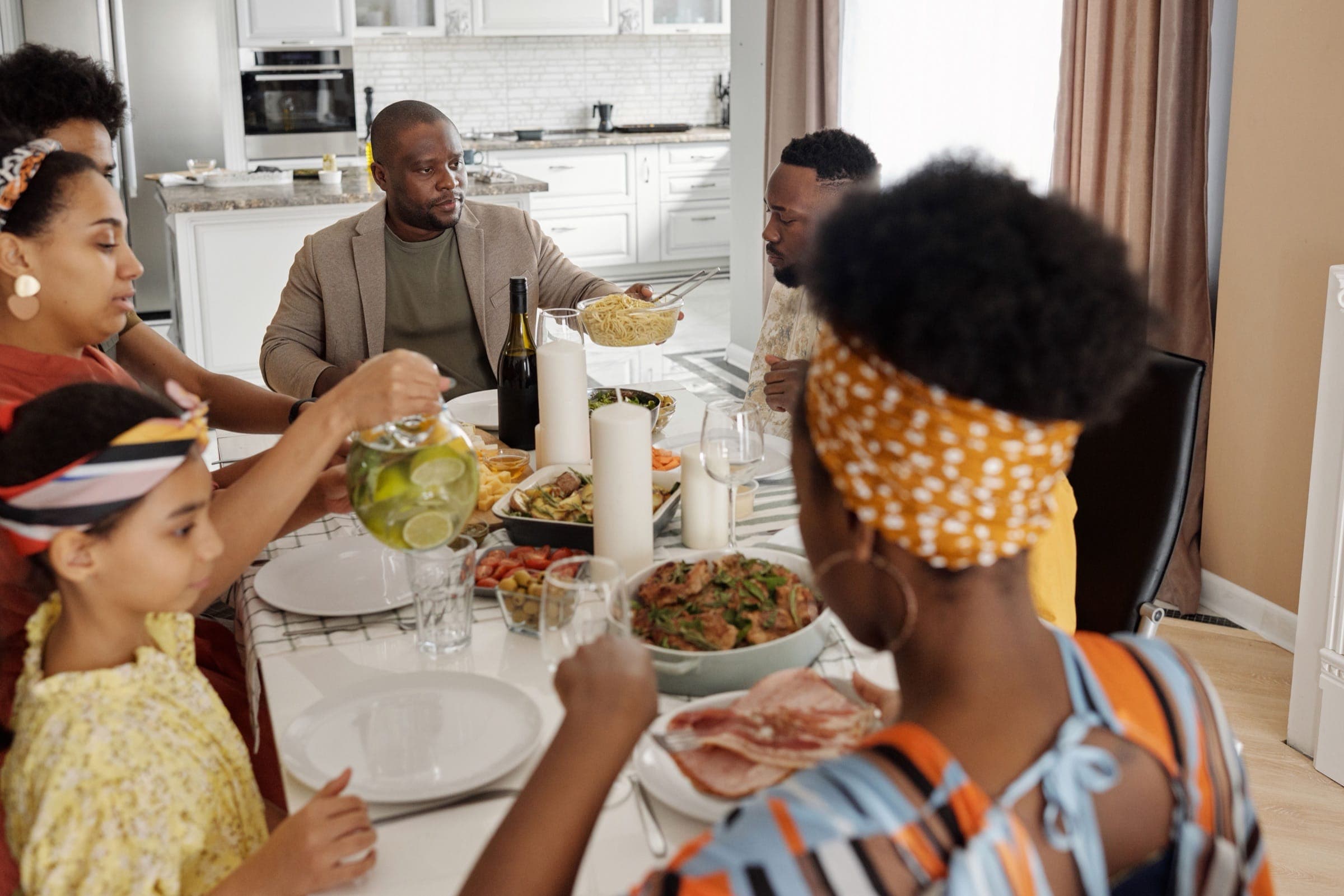 A joyous family gathering enjoying a meal together at home, highlighting togetherness and celebration.